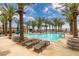 Resort-style pool area with swaying palm trees, comfortable lounge chairs, and inviting umbrellas for relaxation at 24 Cliffwater St, Henderson, NV 89011