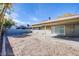 Backyard featuring rock landscaping, covered patio, and block fencing at 26 Jade Circle Cir, Las Vegas, NV 89106