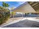 View of backyard featuring a covered patio, rock landscaping and trees at 26 Jade Circle Cir, Las Vegas, NV 89106