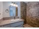 Bathroom featuring granite countertops, tiled shower, updated vanity lighting, and neutral color palette at 26 Jade Circle Cir, Las Vegas, NV 89106