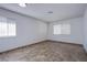 An empty room with tile floors and two windows providing ample natural light at 26 Jade Circle Cir, Las Vegas, NV 89106