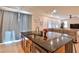 Modern kitchen featuring granite countertops, a stainless steel sink, and gray curtains at 2832 Aragon Terrace Way, Henderson, NV 89044