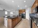 Spacious kitchen with an island, stainless steel appliances, and wood cabinetry at 2832 Aragon Terrace Way, Henderson, NV 89044