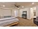 Well-lit bedroom with a bed, crib, mirror, and doorway to the en suite bathroom at 2832 Aragon Terrace Way, Henderson, NV 89044