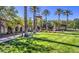 Exterior shot of a community clubhouse featuring landscaped lawns, tall trees, and walking path at 3112 Hayden Ct, Las Vegas, NV 89134