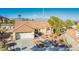 Attractive single-story home featuring a red-tiled roof, two-car garage, and desert landscaping at 3112 Hayden Ct, Las Vegas, NV 89134