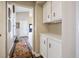 Hallway with colorful rug, leading to other rooms and featuring storage cabinets at 3112 Hayden Ct, Las Vegas, NV 89134