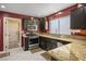 Stylish kitchen with stainless steel appliances, granite countertops, and dark wood cabinets at 3112 Hayden Ct, Las Vegas, NV 89134