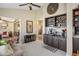 Inviting living room with a decorative ceiling fan, stylish built-in bar and tiled flooring at 3112 Hayden Ct, Las Vegas, NV 89134