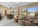 Bright living room with a cozy couch, tile flooring, and a view of the backyard at 3112 Hayden Ct, Las Vegas, NV 89134