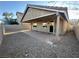 View of covered patio and gravel back yard with block wall at 3208 Paragon Pointe St, Las Vegas, NV 89129