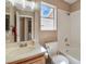 Bright bathroom featuring a window, wood vanity, and a shower-tub combo with tile surround at 3208 Paragon Pointe St, Las Vegas, NV 89129