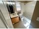 This bathroom features tile flooring, a shower-tub combo, a single sink vanity, and a window for natural light at 3208 Paragon Pointe St, Las Vegas, NV 89129