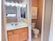 A bathroom with a toilet and vanity, featuring a mirror reflecting a connected bedroom space at 3208 Paragon Pointe St, Las Vegas, NV 89129