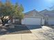 Single-story home boasting a two-car garage, neutral paint, and well-maintained desert landscaping for easy care at 3208 Paragon Pointe St, Las Vegas, NV 89129