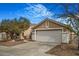 Exterior of a well-maintained home featuring a spacious driveway and two car garage at 3208 Paragon Pointe St, Las Vegas, NV 89129