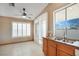 Bright kitchen featuring granite countertops, stainless steel sink, and ample natural light at 3208 Paragon Pointe St, Las Vegas, NV 89129