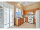 Bright eat-in kitchen featuring tile backsplash, oak cabinets, and modern appliances at 3208 Paragon Pointe St, Las Vegas, NV 89129