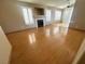 Bright living room featuring wood floors, plantation shutters, fireplace, and neutral paint throughout at 3208 Paragon Pointe St, Las Vegas, NV 89129