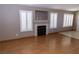 Inviting living room features wood floors, plantation shutters, fireplace, and neutral paint throughout at 3208 Paragon Pointe St, Las Vegas, NV 89129