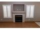 Living room showcasing a fireplace, mantle, tiled hearth, with plantation shutters at 3208 Paragon Pointe St, Las Vegas, NV 89129