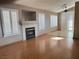 Open living room with fireplace, mantle and tiled hearth, plantation shutters, and ceiling fan at 3208 Paragon Pointe St, Las Vegas, NV 89129