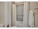 This cozy bathroom features a shower-tub combo, gray stone tile, and a white shower curtain at 3356 Dalmore St, Henderson, NV 89044