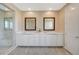 Bright bathroom featuring double sinks, marble counters, square framed mirrors, and a glass-door shower at 3356 Dalmore St, Henderson, NV 89044