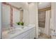 Stylish double vanity bathroom featuring floral accent wall and a shower-tub combo at 3356 Dalmore St, Henderson, NV 89044