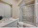 Modern bathroom featuring a glass shower with decorative tile, white vanity, and neutral color palette at 3356 Dalmore St, Henderson, NV 89044