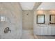 Close up of marble shower with glass surround, including seating, and double sink vanity with marble countertop at 3356 Dalmore St, Henderson, NV 89044