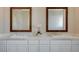 Bathroom vanity featuring double sinks, marble countertops, and a modern orchid in the center at 3356 Dalmore St, Henderson, NV 89044