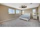 Inviting bedroom with neutral carpeting, a ceiling fan, and a large window overlooking the neighborhood at 3356 Dalmore St, Henderson, NV 89044