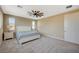 Bedroom featuring neutral colored walls and carpeting, a ceiling fan, and natural light from the window at 3356 Dalmore St, Henderson, NV 89044