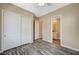 Bedroom with wood-look floors, closet, and a view to the bathroom and its vanity at 3356 Dalmore St, Henderson, NV 89044