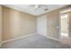 The bedroom boasts neutral walls, plush carpet, ceiling fan, and a closet with sleek sliding doors at 3356 Dalmore St, Henderson, NV 89044