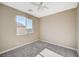 This bedroom features neutral walls, plush carpet, a ceiling fan and a view overlooking the city skyline at 3356 Dalmore St, Henderson, NV 89044