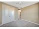 This bedroom features neutral walls, plush carpet, a ceiling fan and a closet with sleek sliding doors at 3356 Dalmore St, Henderson, NV 89044