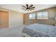 Bedroom features neutral colored walls, carpeting, a ceiling fan, and natural light from the two windows at 3356 Dalmore St, Henderson, NV 89044