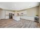 Bright kitchen with a large island, stainless steel appliances, wood-look floors, and white cabinetry at 3356 Dalmore St, Henderson, NV 89044