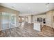 Open concept kitchen and dining area with wood-look floors and a sliding glass door to the patio at 3356 Dalmore St, Henderson, NV 89044