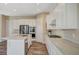 Bright kitchen with a kitchen island, stainless steel appliances, and white cabinets and countertops at 3356 Dalmore St, Henderson, NV 89044