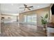 Living room open to the kitchen with wood floors and sliding door to backyard at 3356 Dalmore St, Henderson, NV 89044