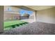 Covered patio featuring brick floors, turf grass and a wood fence at 3356 Dalmore St, Henderson, NV 89044