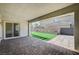 Covered patio featuring brick floors, turf grass and a sliding glass door at 3356 Dalmore St, Henderson, NV 89044