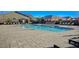 Community pool featuring lounge chairs and bright orange umbrellas for a relaxing and fun atmosphere at 3356 Dalmore St, Henderson, NV 89044