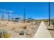 Community walking path and seating area beneath a shaded trellis at 3356 Dalmore St, Henderson, NV 89044