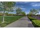 Scenic walking path lined with mature trees and lush landscaping, ideal for a leisurely stroll at 3356 Dalmore St, Henderson, NV 89044