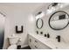 Modern bathroom featuring dual sinks, stylish mirrors, and black hardware at 3543 Algonquin Dr, Las Vegas, NV 89169