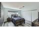 Bedroom featuring a spacious closet, a window, rustic bedside tables and stylish wood look flooring at 3543 Algonquin Dr, Las Vegas, NV 89169